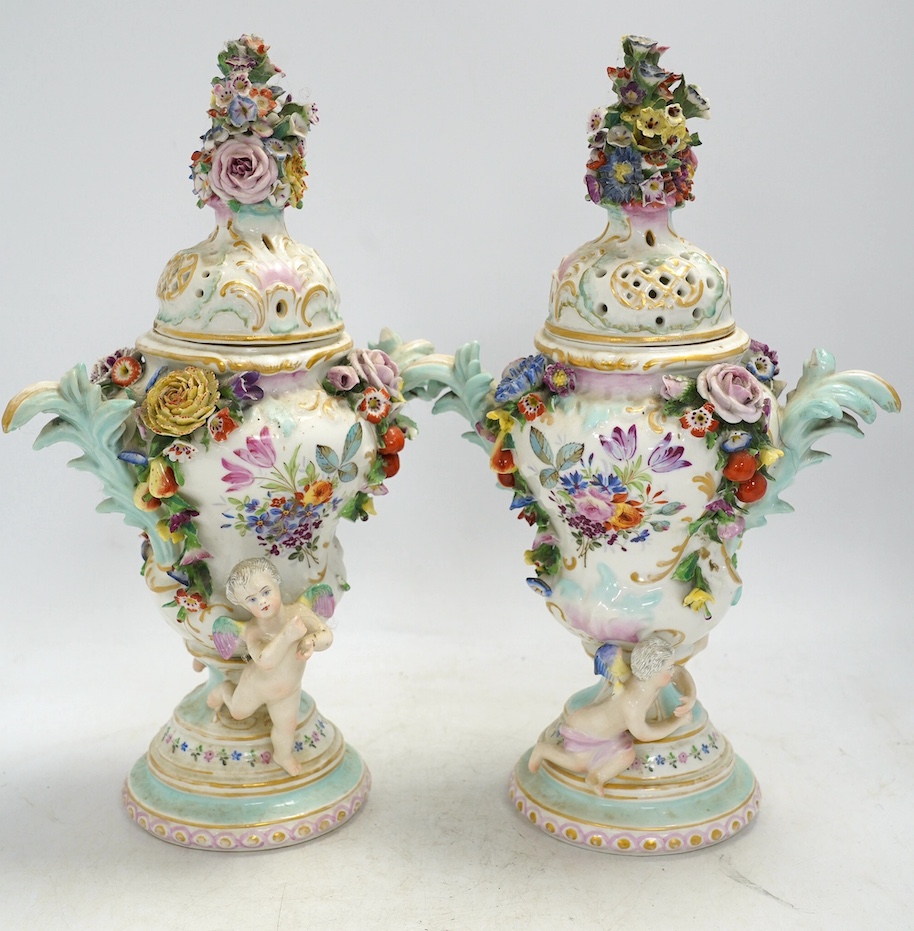 A pair of Potschappel porcelain floral encrusted vases and covers, 31cm high. Condition - poor
